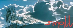 banner image showing a landscape, clouds, and sun